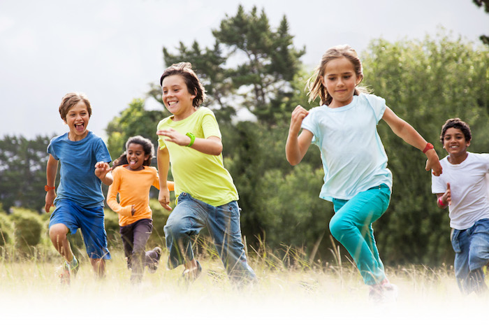 Children running together in a park